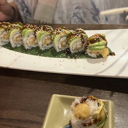 a plate of sushi and chopsticks