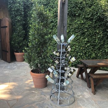 Rombauer Vineyards - One of the picnic tables and the entrance to the cave at left -- push the button and you're in! - Wineries Near Me - St. Helena, California