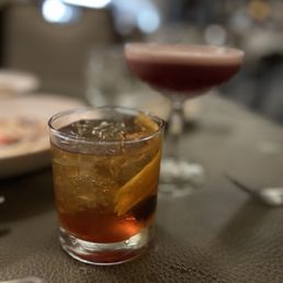 a glass of cocktail on a table a glass of cocktail on a table