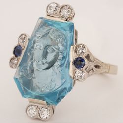 Atlanta Diamond Design - Antique estate ring featuring a relief carving of a lady's likeness into the aquamarine center, set in 18k white gold with diamond, sapphire