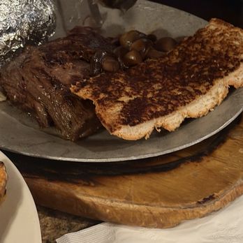 Steer N' Stein - Steak with baked potato and garlic bread and some marinated mushrooms on the side - Steakhouses Near Me - Rancho Cucamonga, California Steer N' Stein - Steak with baked potato and garlic bread and some marinated mushrooms on the side - Steakhouses Near Me - Rancho Cucamonga, California