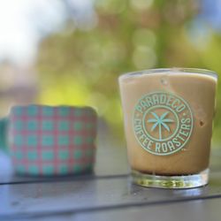 Paradeco Coffee Roasters - Iced coffee served in glassware and hot coffee in a ceramic coffee cup.