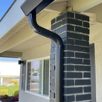 AI Exteriors - the corner of a brick building - Gutter Services Near Me
