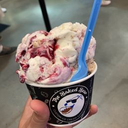 a hand holding a cup of ice cream a hand holding a cup of ice cream