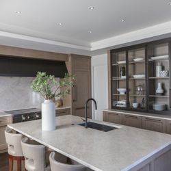 Evolo Design - Walnut cabinetry pairs beautifully with leathered white countertops.