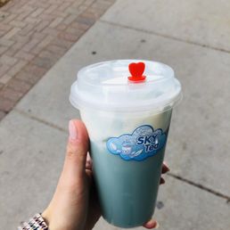 a hand holding a cup of coffee