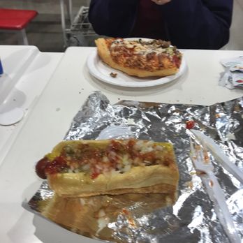 Costco Wholesale - a person eating a hot dog - Grocery Near Me - Ogden, Utah Costco Wholesale - a person eating a hot dog - Grocery Near Me - Ogden, Utah