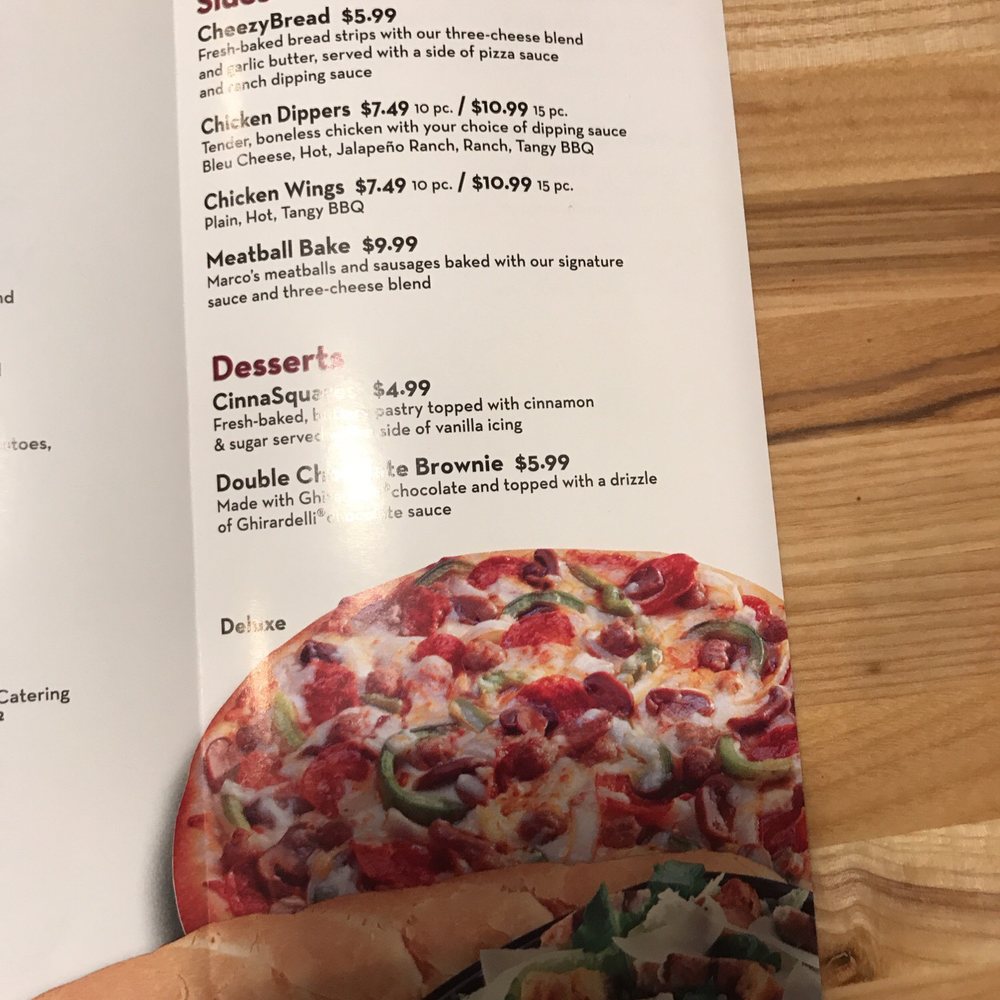 Marco's Pizza - a hand holding a menu - Pizza Near Me - Spartanburg, South Carolina Marco's Pizza - a hand holding a menu - Pizza Near Me - Spartanburg, South Carolina