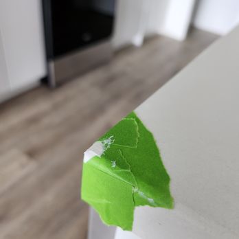 Kinslee Design and Installation - a green leaf sticking out of a kitchen counter - Tiling Near Me Kinslee Design and Installation - a green leaf sticking out of a kitchen counter - Tiling Near Me