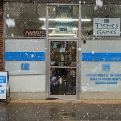 Tyche's Games - Storefront during snowfall.