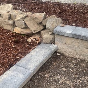 Archiscape - Stacked rocks "meet" newly built walls. - Masonry/Concrete Near Me Archiscape - Stacked rocks "meet" newly built walls. - Masonry/Concrete Near Me