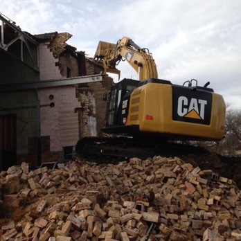 Todd O. Brueske Construction - a cat excavator on a pile of rubble - General Contractors Near Me Todd O. Brueske Construction - a cat excavator on a pile of rubble - General Contractors Near Me