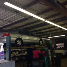 Lady inspecting my blown muffler. Lady inspecting my blown muffler.