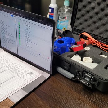 Integrative Performance - A workspace featuring a laptop displaying an email inbox, a medical testing device, and a foam-padded case with testing tools. - Nutritionists Near Me - Arlington, Virginia