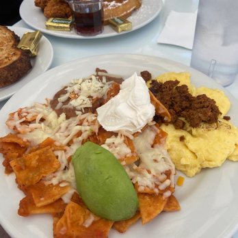 Brekkies - Chilaquiles with chorizo, scrambled egg, refried beans, avocado, and sour cream - Breakfast & Brunch Near Me - Solvang, California Brekkies - Chilaquiles with chorizo, scrambled egg, refried beans, avocado, and sour cream - Breakfast & Brunch Near Me - Solvang, California