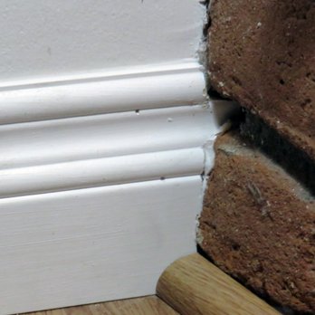 Universal Floor Covering - The installer took precise measurements even here, and he cut the baseboard to fit precisely against the brick face. - Flooring Near Me - San Dimas, California