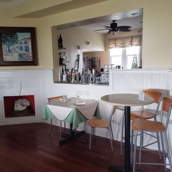 The Inn Spot On The Bay - a table and chairs - Seafood Near Me - Hampton Bays, New York
