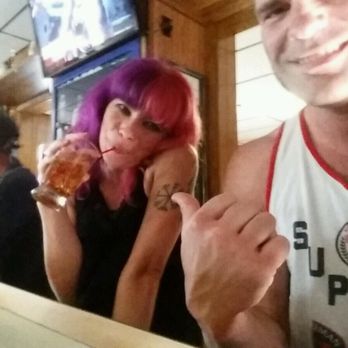 Bell Bar - a man and a woman eating pizza - Pubs Near Me - Bay City, Michigan