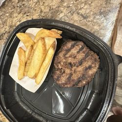 Adult hamburger steak cooked medium well plain with fries