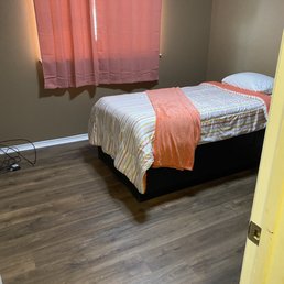a bedroom with a bed and a window