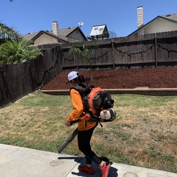 Garden Awakenings - a woman carrying a backpack and a hose - Gardeners Near Me Garden Awakenings - a woman carrying a backpack and a hose - Gardeners Near Me
