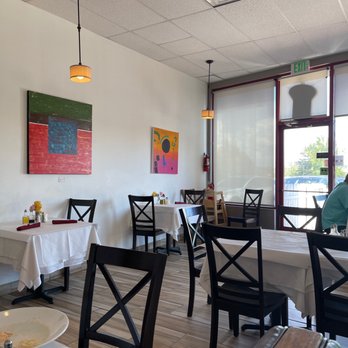 Cafe Grazie - a woman sitting at a table - Italian Near Me - Santa Fe, New Mexico Cafe Grazie - a woman sitting at a table - Italian Near Me - Santa Fe, New Mexico