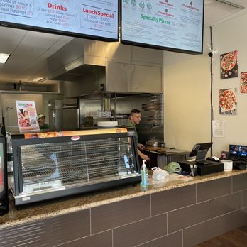 Round Pizza & Wings - a man working in a restaurant - Chicken Wings Near Me - Roseville, California Round Pizza & Wings - a man working in a restaurant - Chicken Wings Near Me - Roseville, California