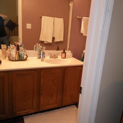 Creative Home Renovations - Remodeled master bathroom room with stone tiled flooring.