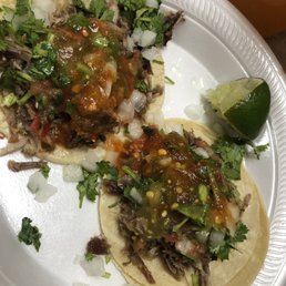 two tacos on a paper plate