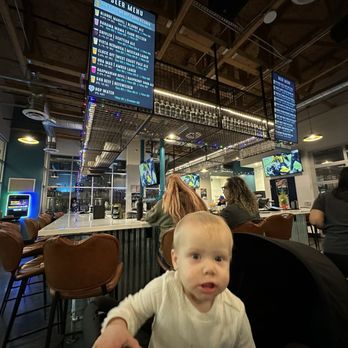 Left Coast Brewing - My daughter inserting herself into a picture of the bar - Distilleries Near Me - Ontario, California