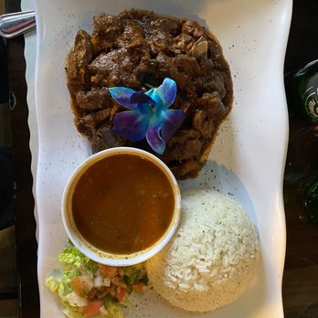 Tainos Cafe & Lounge - El Taino Caliente Chive - Goat Stew Creole Style - Latin American Near Me - Coram, New York Tainos Cafe & Lounge - El Taino Caliente Chive - Goat Stew Creole Style - Latin American Near Me - Coram, New York