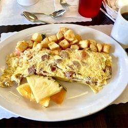 Speggtacular - Athenian 5 egg . Greek sausage (pork lamb, orange zest), tomato, feta, & onion. So delicious and unique!!
