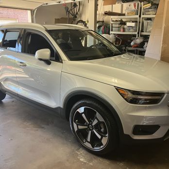 Austin Vol-Tech - Snowball - A white SUV is parked inside a garage with shelving units and storage boxes visible in the background. - Auto Repair Near Me - Austin, Texas