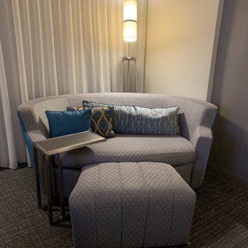 Courtyard by Marriott Longview North - This couch was super comfy and the little table was perfect to eat on while watching tv - Hotels Near Me - Longview, Texas