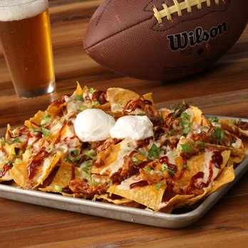 Hickory Tavern - a tray of nachos and a football - American Near Me - Holly Springs, North Carolina Hickory Tavern - a tray of nachos and a football - American Near Me - Holly Springs, North Carolina