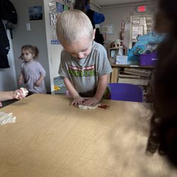 New Discoveries Christian Child Care and Development - Our Preschool room playing with playdoh snow that they made in class. Hands on learning!