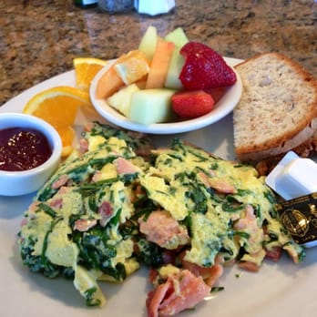 Custom scramble w/ smoked salmon, spinach, and chives. Side of fruit and gluten-free toast. YUM.