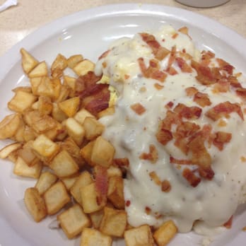 The Big Biscuit - Lawrence - Country Benedict! A big biscuit covered in your choice of sausage patty or bacon, scrambled eggs, gravy, and breakfast potatoes! - Breakfast & Brunch Near Me - Lawrence, Kansas