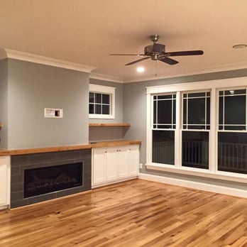 Concept 8 - a living room with hardwood floors and a fireplace - General Contractors Near Me - Apex, North Carolina
