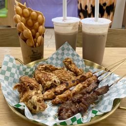 Chicken & beef skewers, fried chicken wings, bubble waffle, iced milk tea.