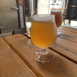 two glasses of beer on a wooden table