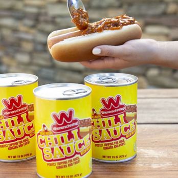 Wienerschnitzel - a person holding a hot dog and three cans of chili sauce - Fast Food Near Me - Palmdale, California Wienerschnitzel - a person holding a hot dog and three cans of chili sauce - Fast Food Near Me - Palmdale, California