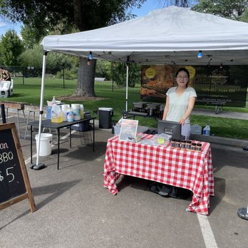 AsianStreet - a woman standing under a tent - Thai Near Me - Carson City, Nevada