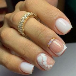 StarNailsBar - Elegant and timeless! This soft milky-white French manicure features delicate floral details,
