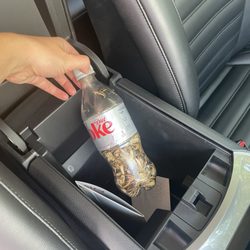 Coke bottle with used sunflower seeds and documents of other renters with personal identifying info on them