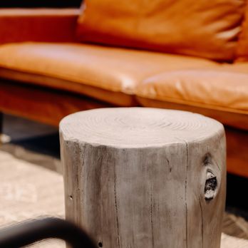 Black Arrows Coffee - a leather couch and a wooden table - Coffee Roasteries Near Me - Seattle, Washington