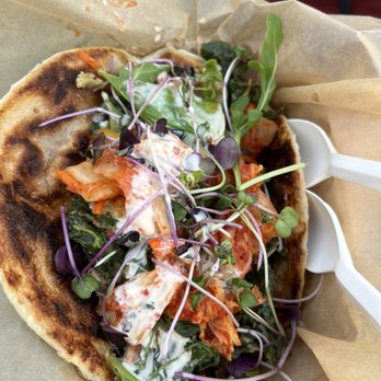 Roti Rolls - a close up of a roti roll with a salad on it - Food Trucks Near Me