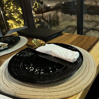 Sanduk - a place setting with black plates and silverware - Filipino Near Me - Ottawa, Ontario Sanduk - a place setting with black plates and silverware - Filipino Near Me - Ottawa, Ontario