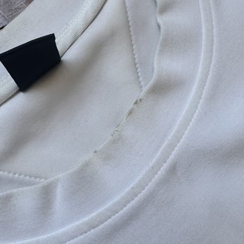 Look at the collar, there are stains and the blouse looks grey. It looks old after it came back