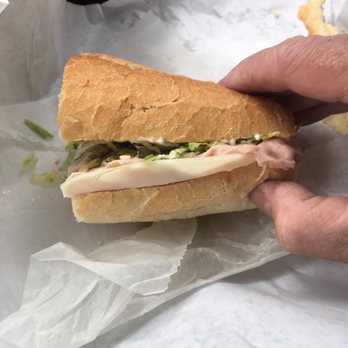 Subslingers - a hand holding a sub sandwich - Sandwiches Near Me - Scotch Plains, New Jersey